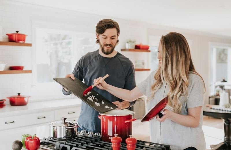 Two family members cooking together at home